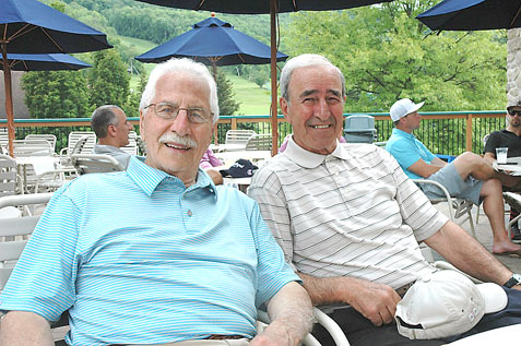 Gabe Panebianco, left, and Tom Michos relax after completing the first round of the Italian-American Charity Golf Classic Tuesday. Panebianco has played in the event all 45 years of its existence, including the last 43 with Michos, his lifelong friend. P-J photos by Scott Kindberg