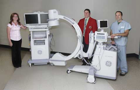 Tammara L. C. Hodges, left, director of Imaging Services at WCA Hospital, and Jeremy Carmen, right, radiology technologist, show off the new Fluoroscopic C-Arm to Chris D’Angelo, board member of the Italian American Charity Golf Association. The purchase of a Fluoroscopic C-Arm was made possible by the fundraising efforts of the Italian American. Submitted photo