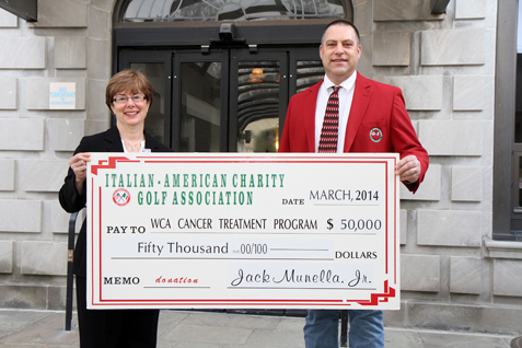 Jack Munella Jr., chair of the Italian American Charity Golf Association, presents a check in the amount of $50,000 to Betsy Wright, WCA Hospital president/CEO, representing the proceeds from the Italian American’s 2013 fundraising activities and the first installment of a three-year, $150,000 pledge to enhance local cancer care at WCA Hospital through the purchase of a Fluoroscopic C-Arm.