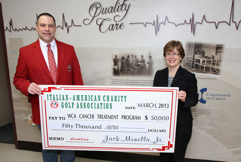 Jack Munella Jr., chair of the Italian American Charity Golf Association, presents a check in the amount of $50,000 to Betsy Wright, WCA Hospital president/CEO, representing the proceeds from 2012 Italian American and the final installment of a three-year, $150,000 pledge for the purchase of Electromagnetic Navigation Bronchoscopy to aid in the diagnosis and treatment of lung cancer at WCA.